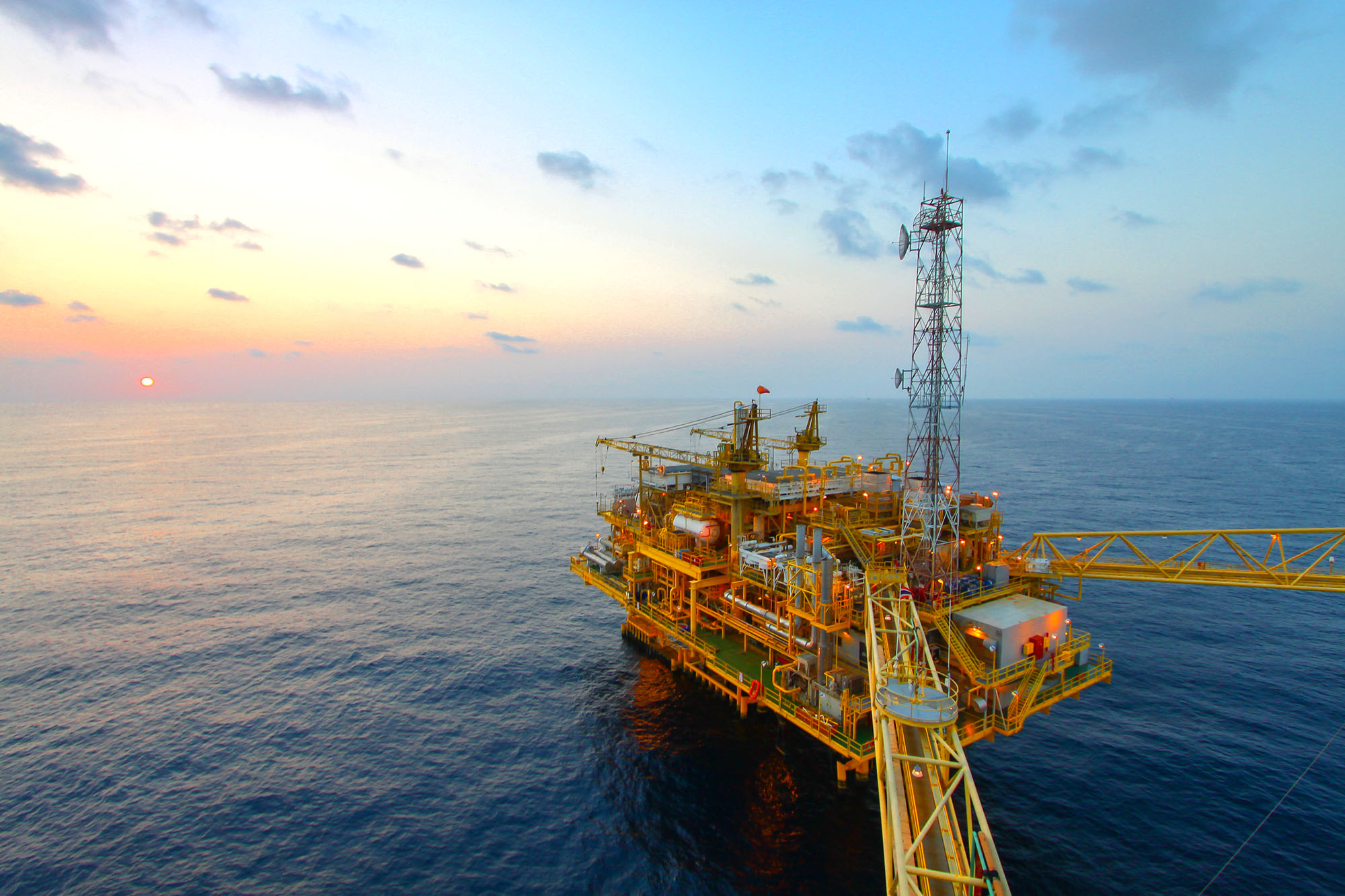Oil and gas platform in sunset or sunrise time Oil and gas platform in sunset or sunrise time